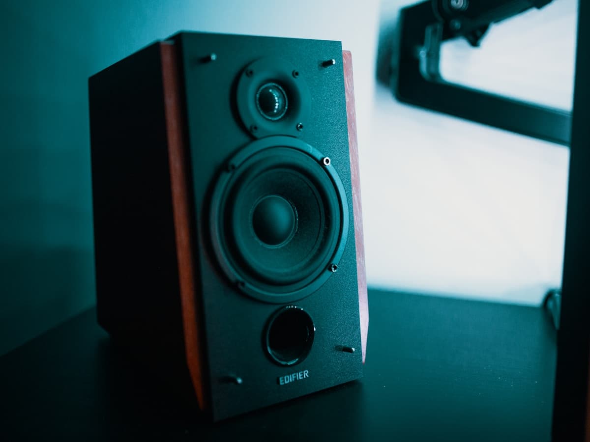 Compact desktop speaker beside a monitor