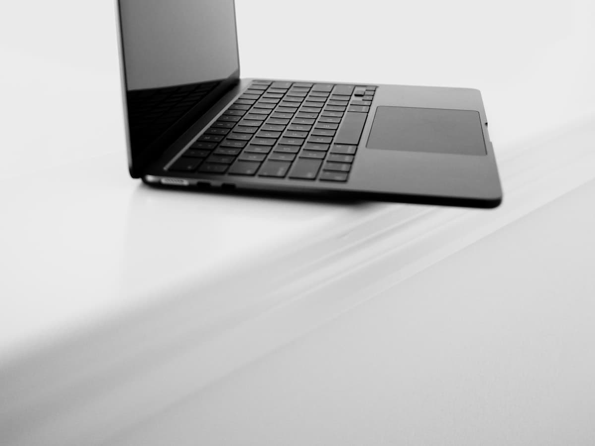Silver laptop open on a wooden desk