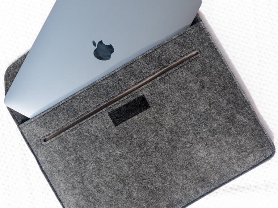 Gray felt laptop sleeve with a laptop partially inserted
