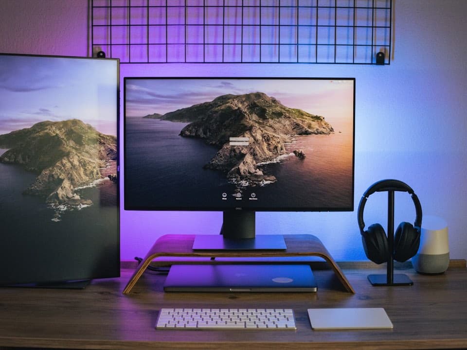 Wooden monitor stand organizing a desktop workspace