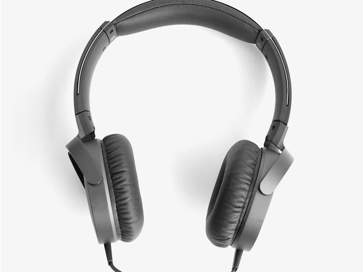 Black over-ear headphones on a yellow backdrop