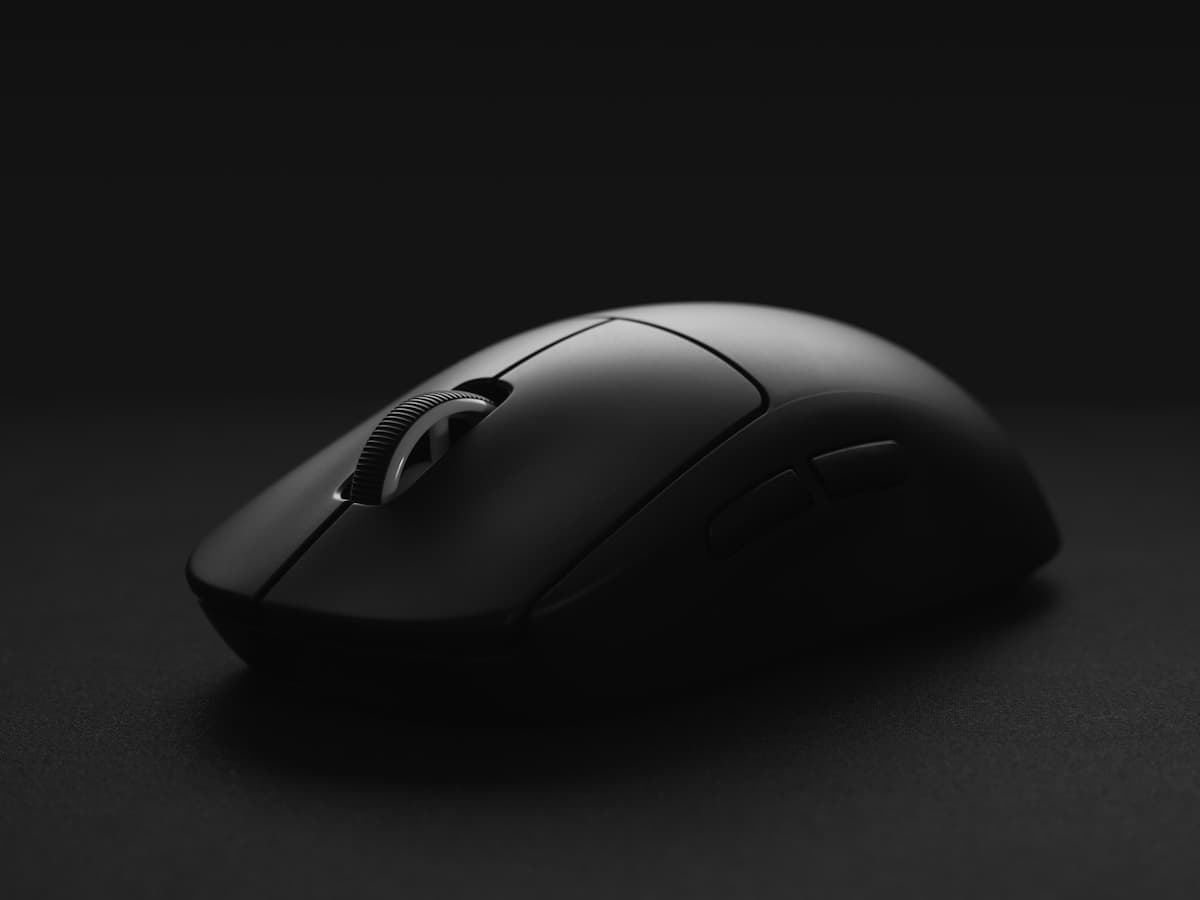 Black wireless mouse on a dark studio surface